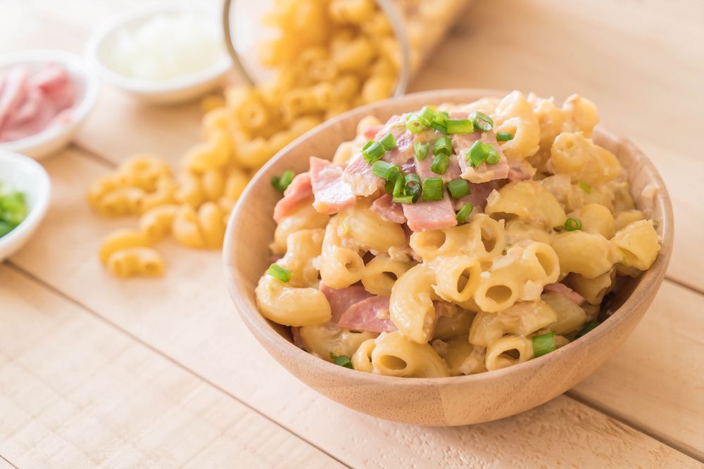 A bowl of macaroni cheese with ham from the kids menu
